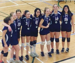 Premier League championship team in navy blue uniforms with medals