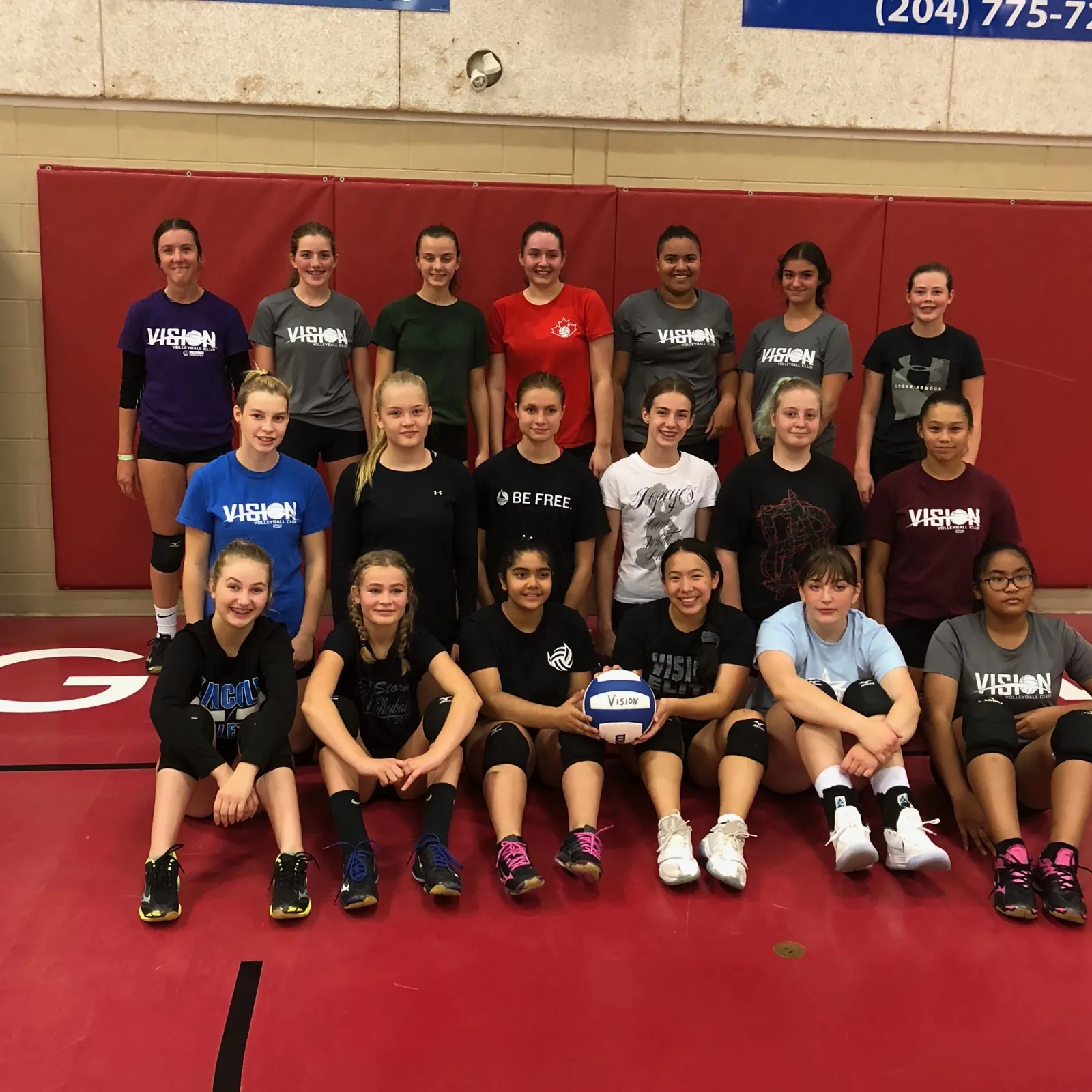 Smiling VISION camp athletes in team shirts